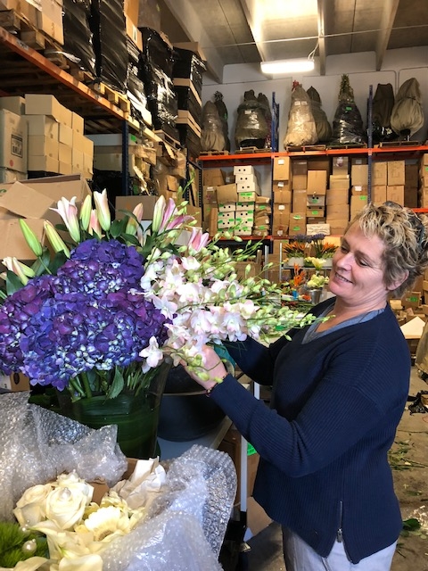 Florist holding a purple bouquet