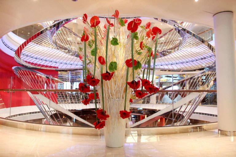 Tall flower frame with red flowers in the atrium