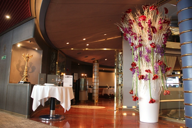 tall pink and purple flower arrangements on a cruise ship
