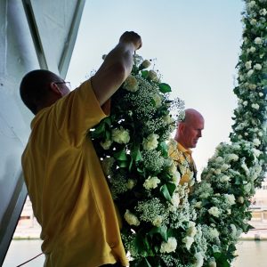 Dianthus International florist holding a flower garland on a cruise ship
