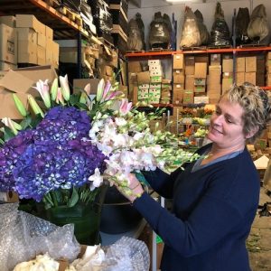 Florist holding a purple bouquet